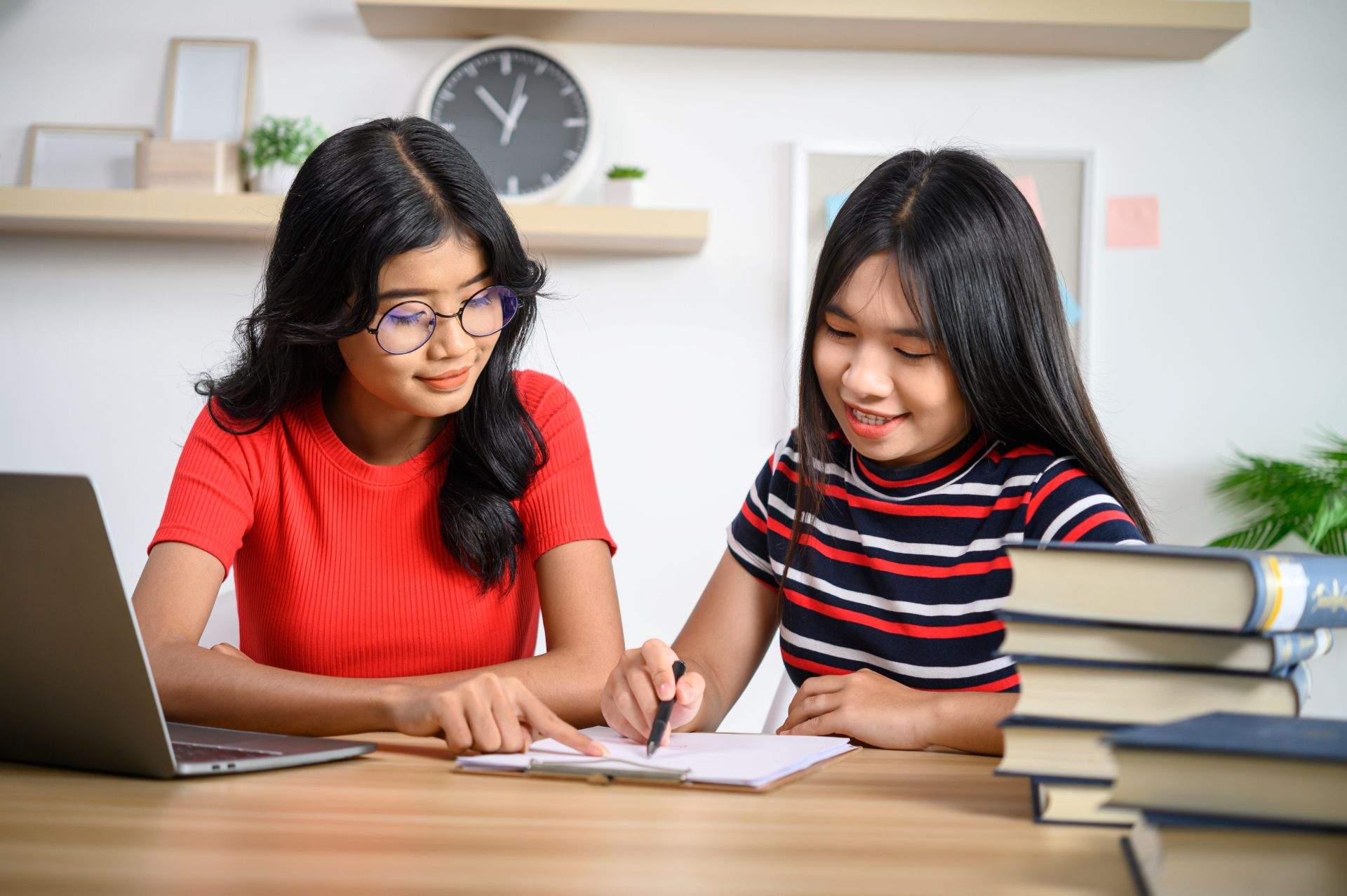 two young women working with laptops