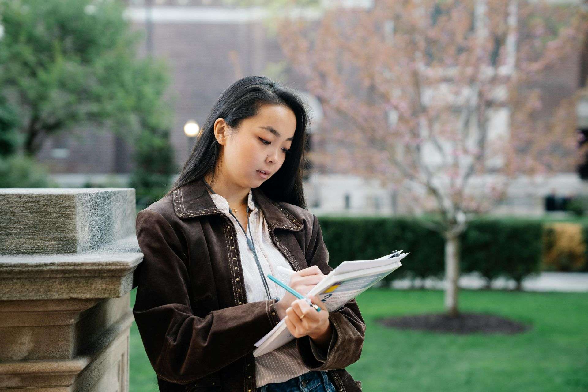 student writing on a book