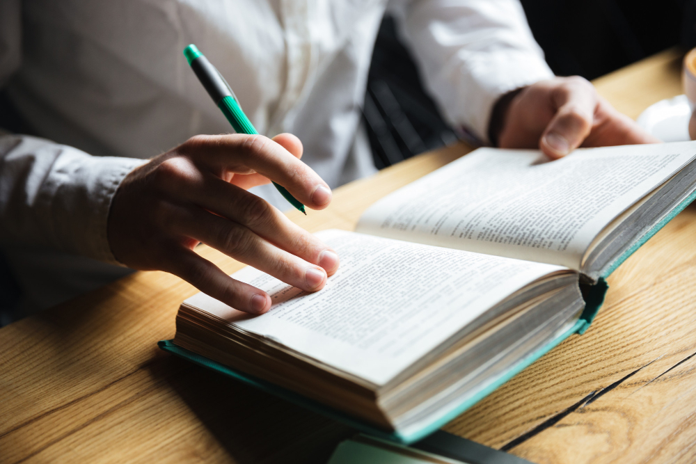 man-holding-pen-book