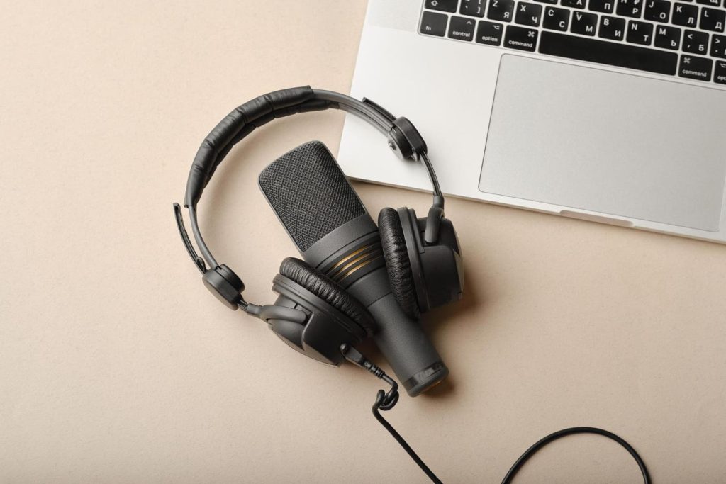 Microphone for podcasts and black studio headphones.