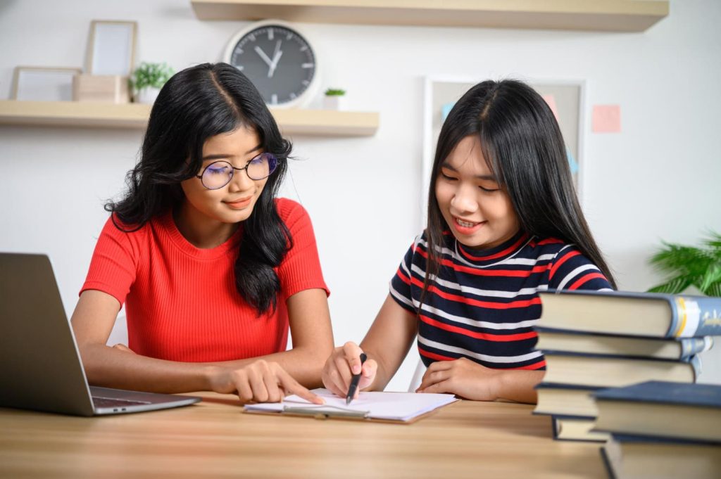 Two young women working together.