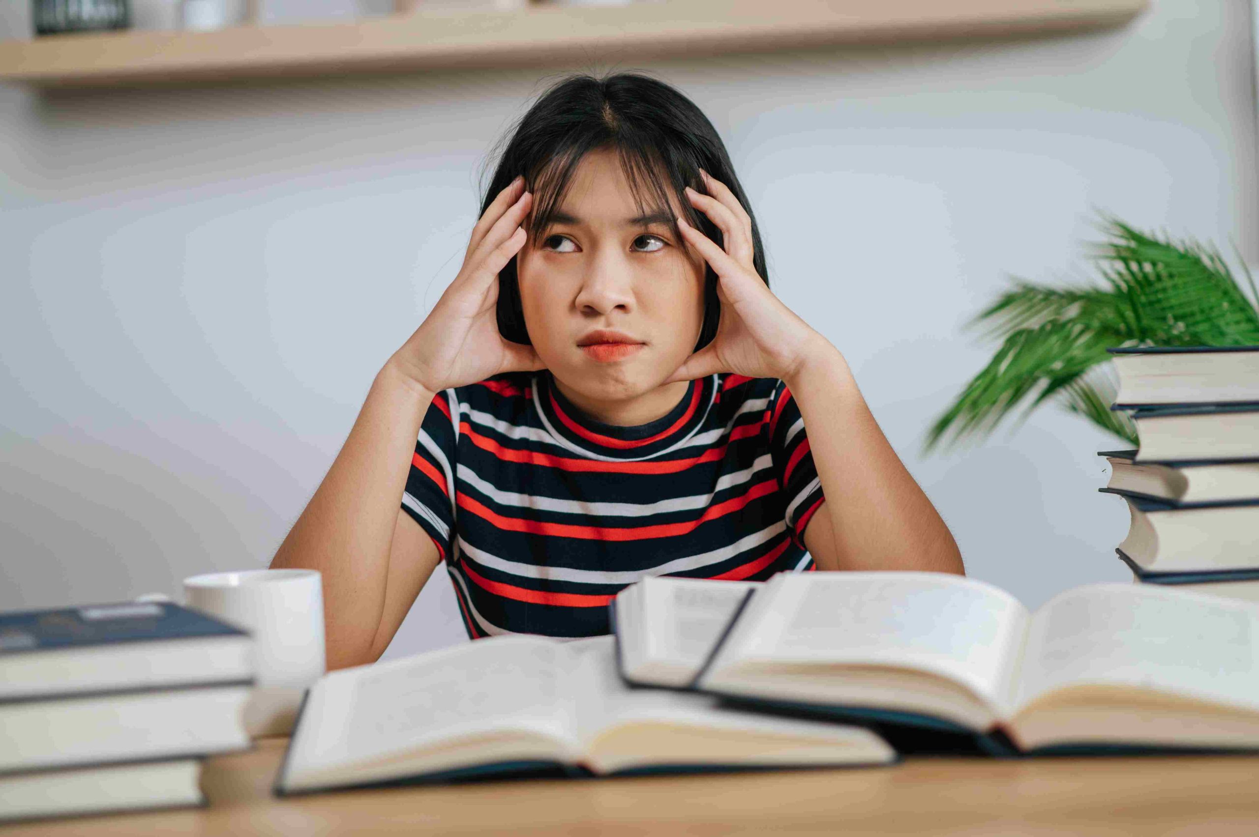 young-woman-working-on-books-looking-stressed
