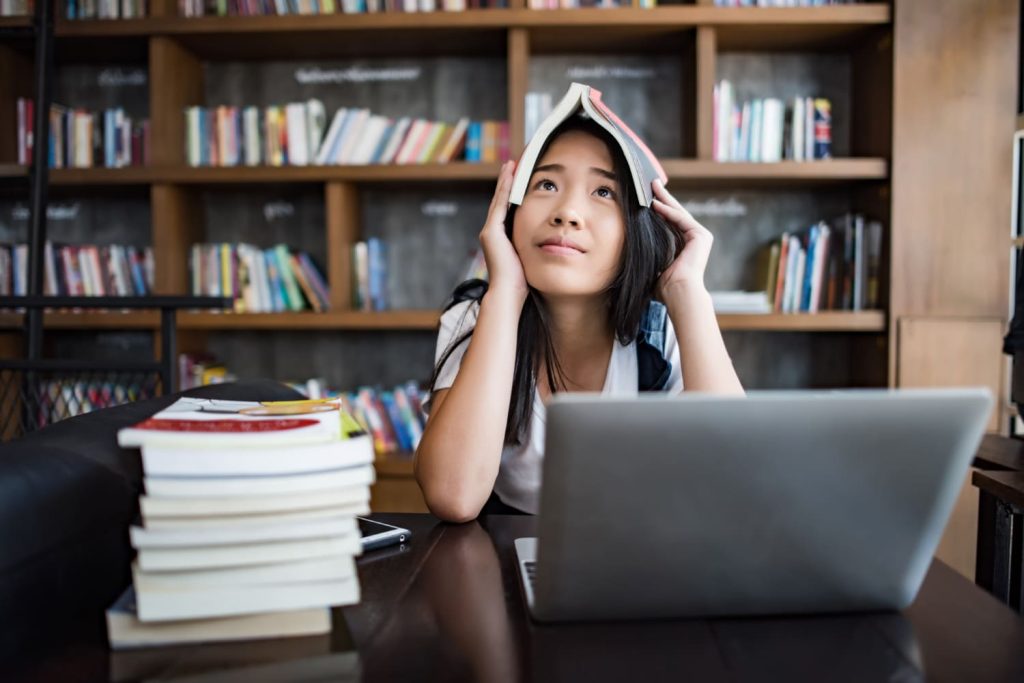 young-woman-looking-stressed-in-library