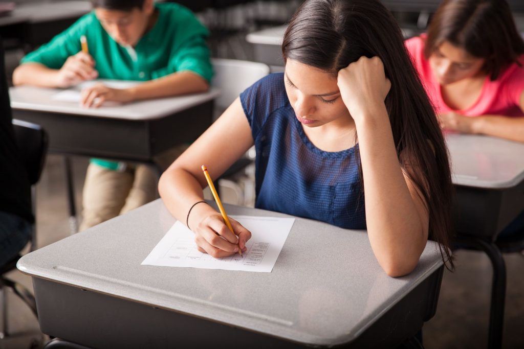 group high school students taking test classroom_