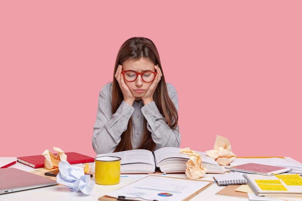 student sitting desk with documents_