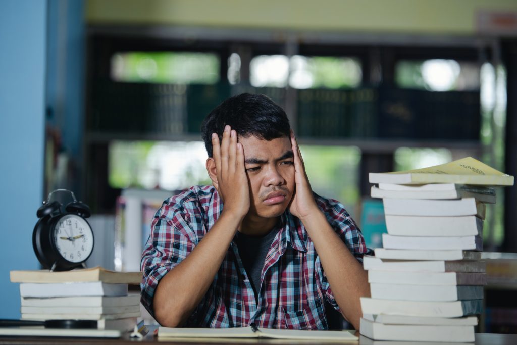 educational-conept-tired-student-library