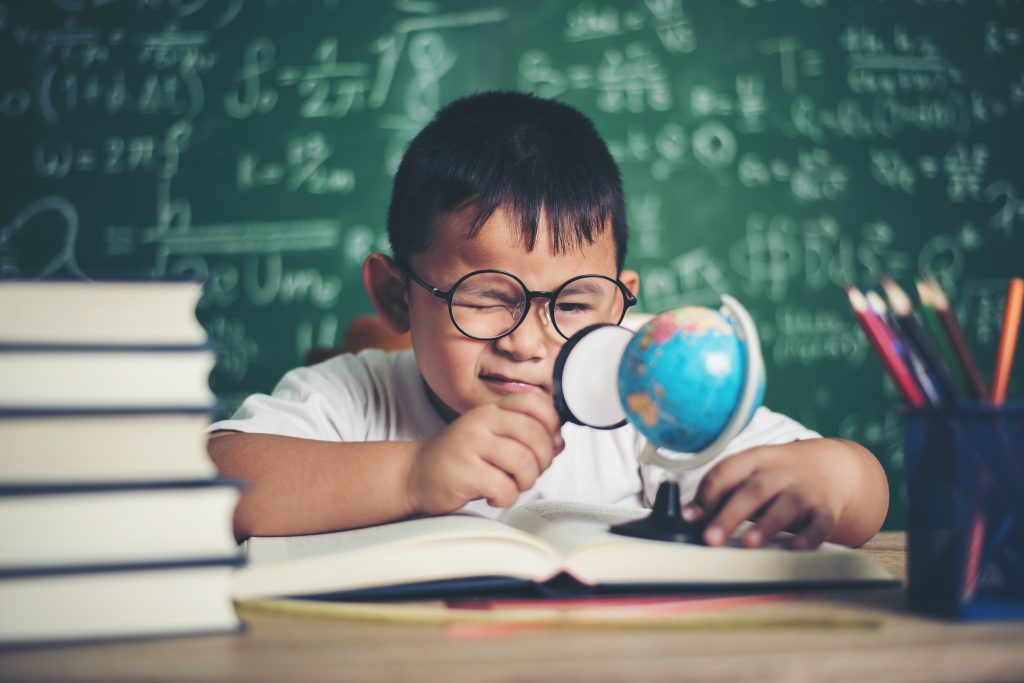 kid-observing-studying-educational-globe-model-classroom